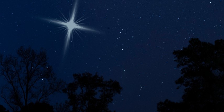 View of a bright star in a dark night sky.