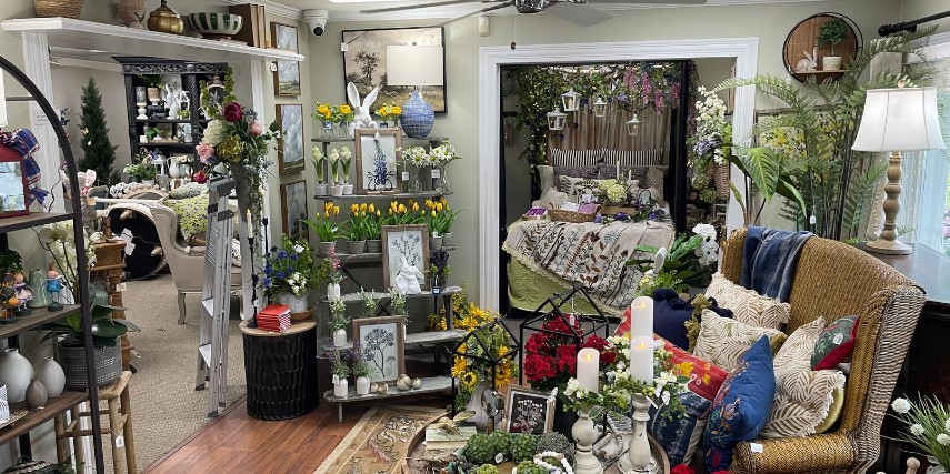 View of a bedroom display and living area decor in a boutique store.