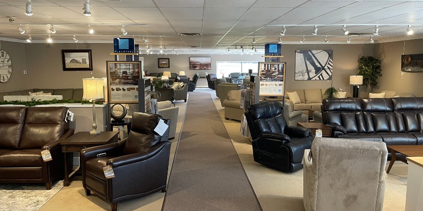Interior of Colony House Furniture and Bedding with a long aisle between a wide selection of furniture.