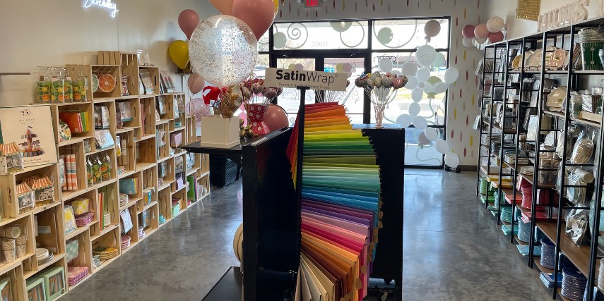 Interior view of a balloon store shows wide selection of balloon-related products. 