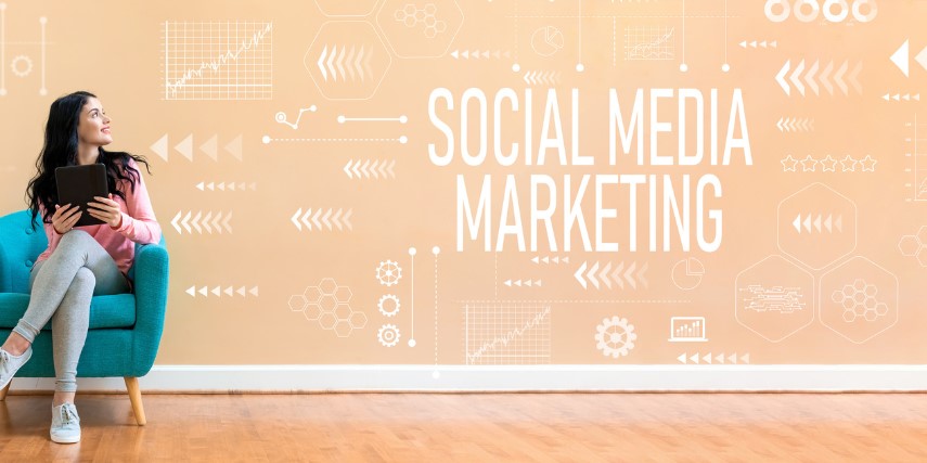 A woman sits in a blue chair against a salmon-colored wall, looking up at the words, "social media marketing."